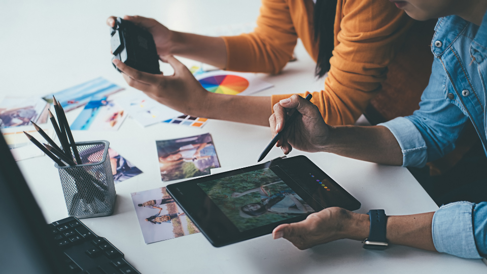 Two sellers working on creating Amazon ads for their products