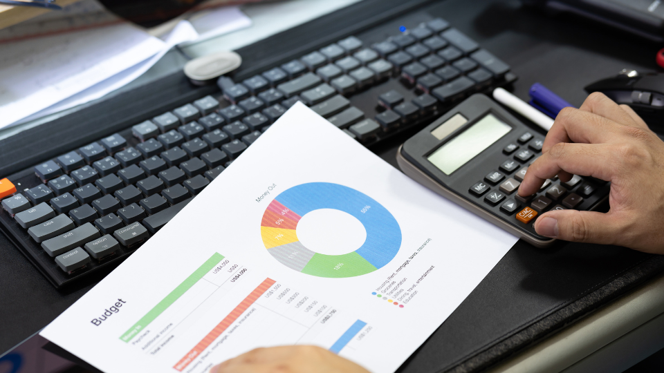 A person is using a calculator to optimize an Amazon advertising budget