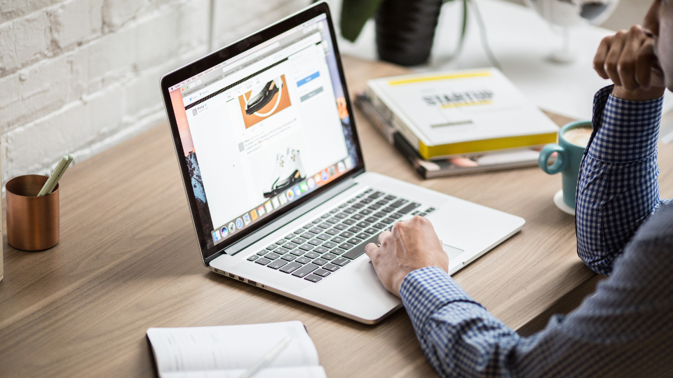 A person checking their Amazon Brand Analytics on their laptop