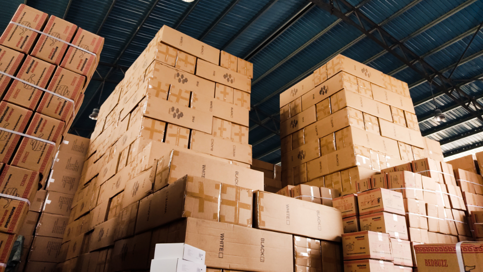 Many cardboard boxes stacked in a warehouse used by Amazon wholesalers