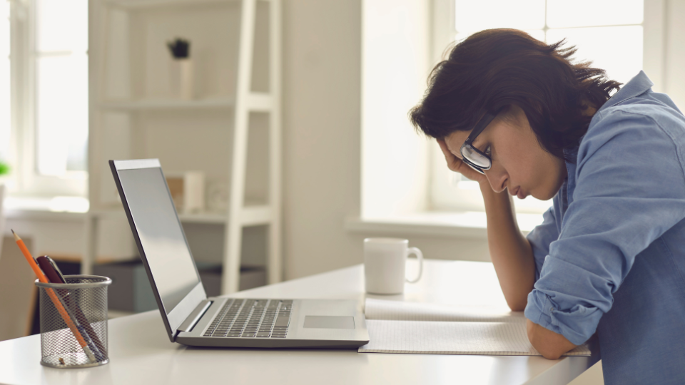 An ecommerce entrepreneur looking frustrated at their desk