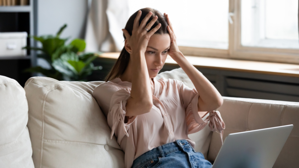 A frustrated customer looking at a laptop