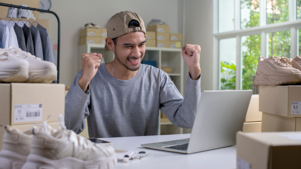 A happy ecommerce professional celebrates another sale