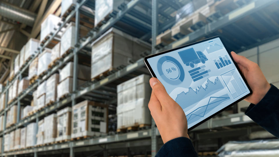 Two hands holding a tablet with an inventory management software on it
