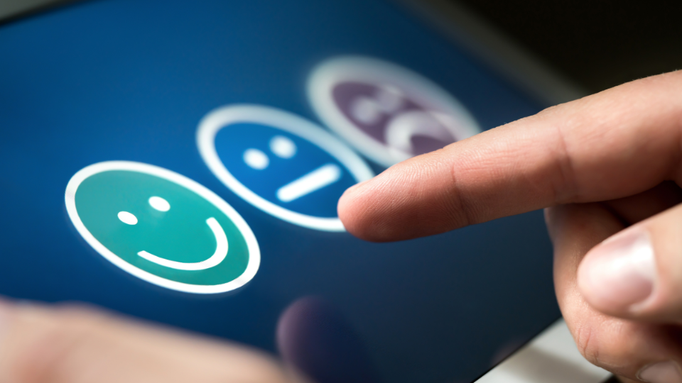 An up close shot of a person leaving a happy face review